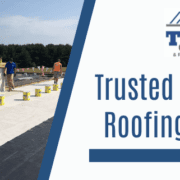 Commercial roofers working with the message "Trusted Commercial Roofing Solutions" by Tusing Builders.